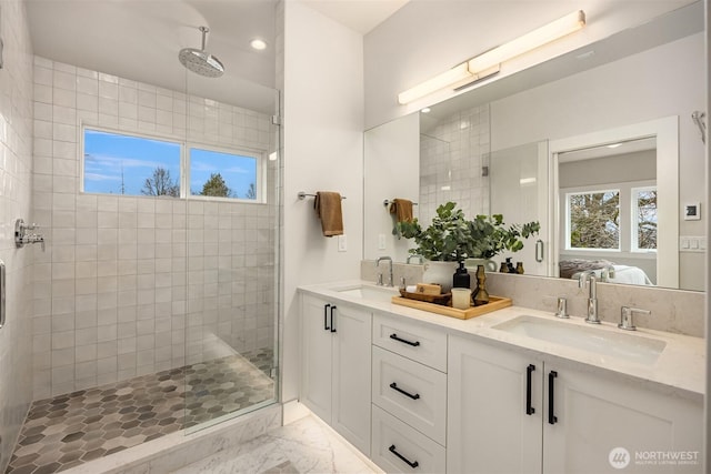 full bathroom featuring ensuite bath, a stall shower, and a sink