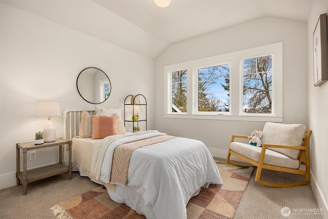 bedroom featuring light colored carpet, baseboards, and vaulted ceiling