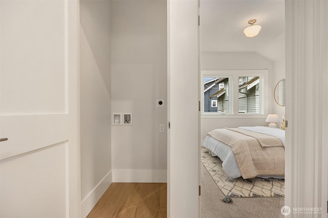 bedroom featuring baseboards and wood finished floors