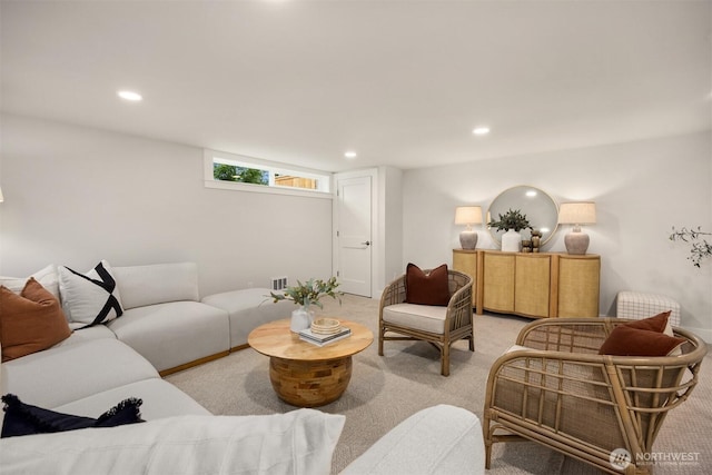 living room featuring recessed lighting, light colored carpet, and visible vents