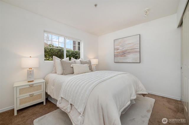 carpeted bedroom featuring baseboards