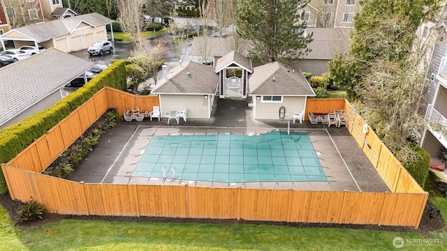 view of swimming pool featuring a residential view, a fenced in pool, fence private yard, and a patio