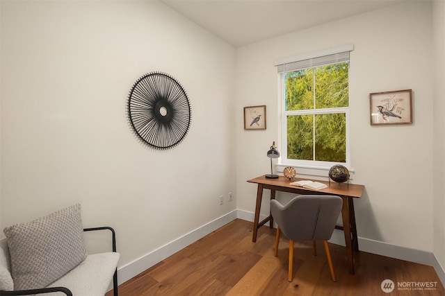 office space featuring baseboards and wood finished floors