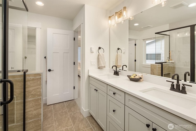 bathroom featuring a sink, visible vents, and a stall shower