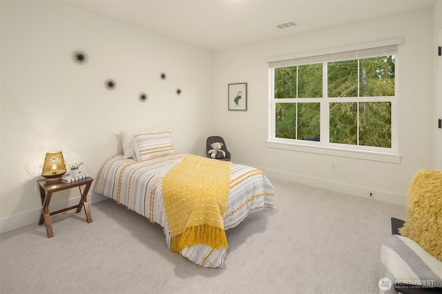 bedroom featuring light colored carpet, visible vents, and baseboards