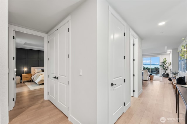 corridor with recessed lighting and light wood-style floors