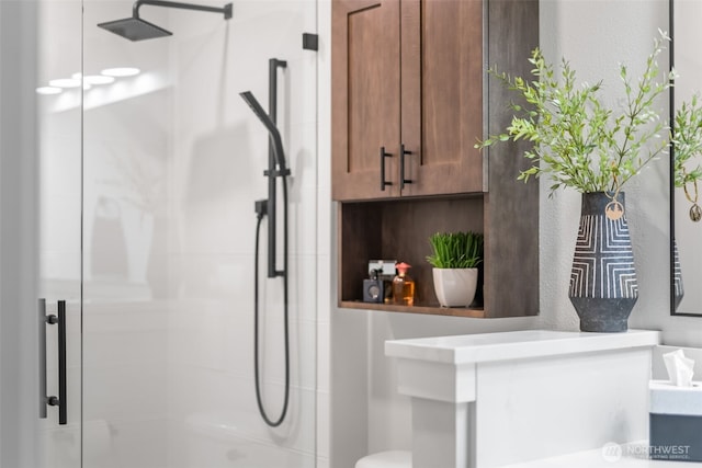 bathroom featuring vanity, toilet, and a stall shower