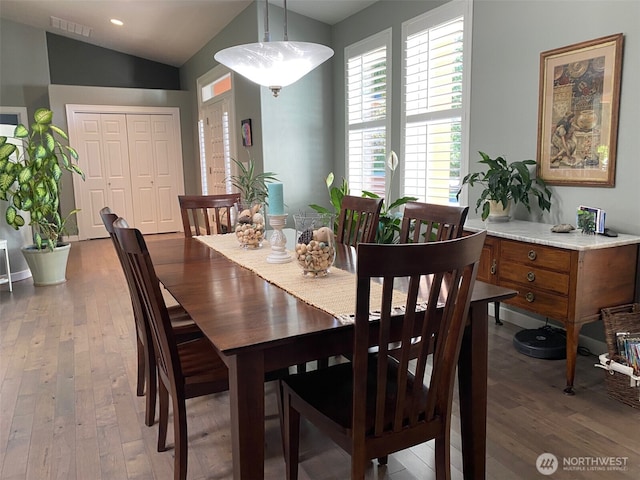 dining space featuring vaulted ceiling, hardwood / wood-style flooring, recessed lighting, and visible vents