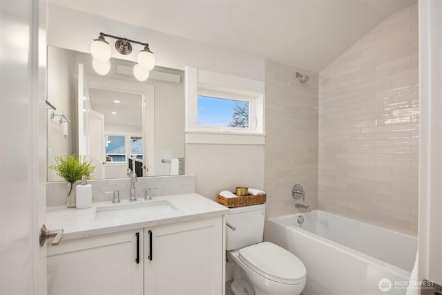 full bathroom with lofted ceiling, toilet, a healthy amount of sunlight, and shower / washtub combination