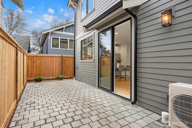 view of patio with ac unit and a fenced backyard