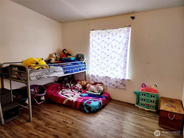 bedroom featuring wood finished floors