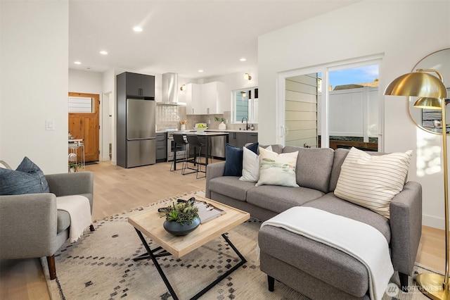 living area with recessed lighting and light wood-type flooring