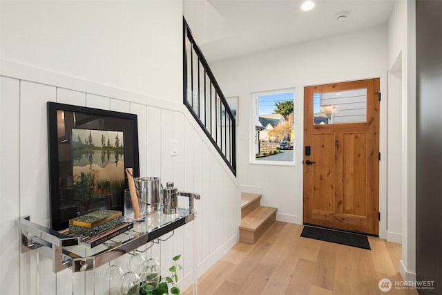 foyer featuring recessed lighting, stairway, light wood-style flooring, and baseboards