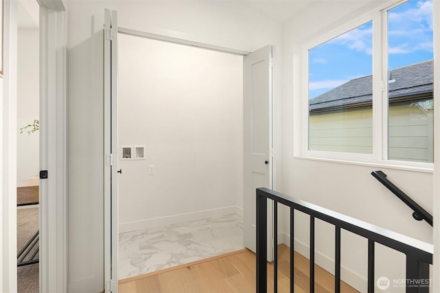 corridor featuring baseboards and marble finish floor