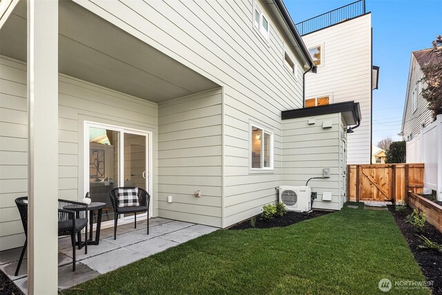 rear view of property featuring a patio, ac unit, fence, and a lawn