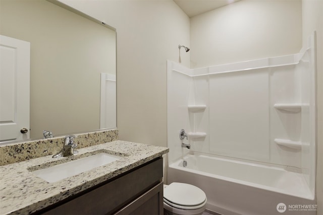 bathroom featuring toilet, vanity, and shower / bath combination