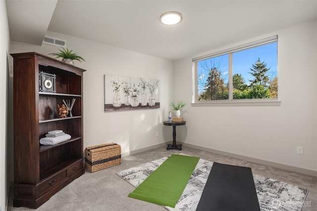 exercise room featuring visible vents, baseboards, and carpet floors