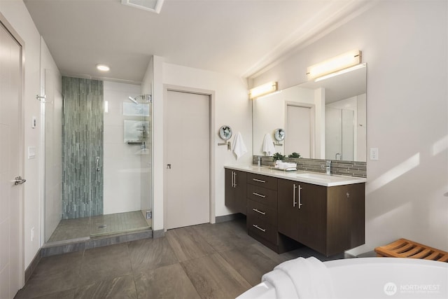 bathroom with visible vents, a shower stall, vanity, and a freestanding tub