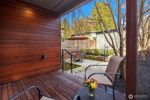 wooden terrace featuring a patio area and outdoor dining space