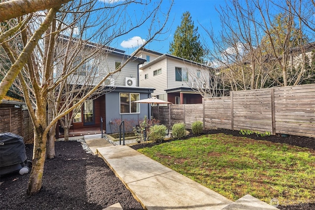 back of property featuring a yard and fence private yard