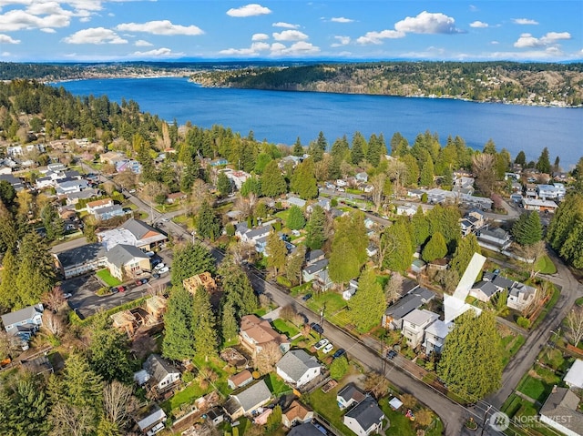 drone / aerial view with a residential view and a water view