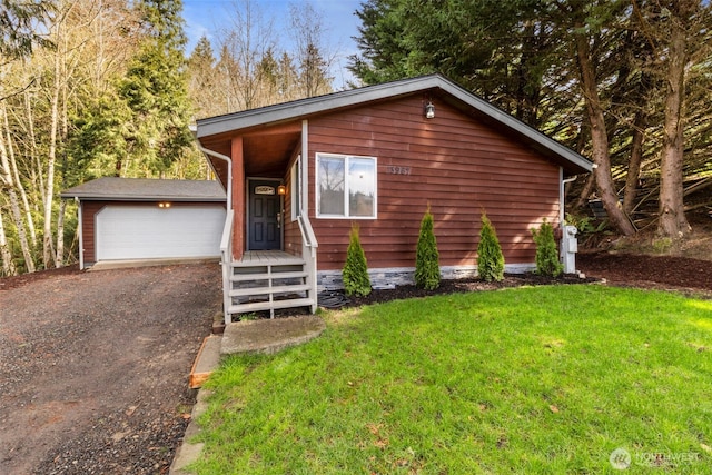 rustic home featuring a garage, driveway, and a front yard