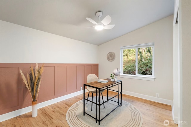 office with baseboards, a ceiling fan, light wood-style floors, and vaulted ceiling