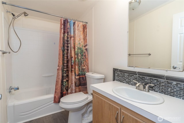 bathroom featuring toilet, backsplash, wood finished floors, shower / bath combination with curtain, and vanity