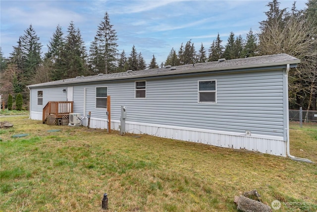 rear view of property with a yard