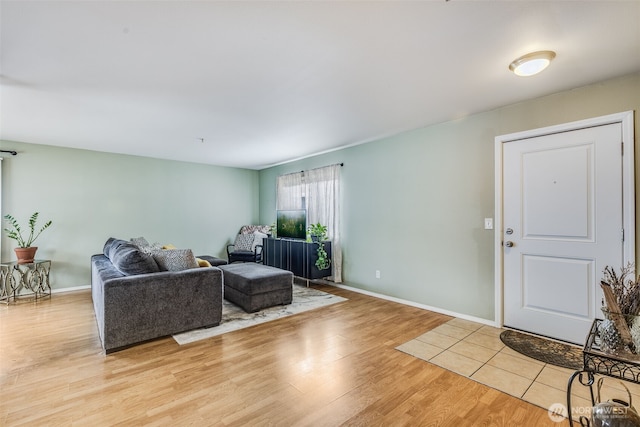 living room with light wood finished floors and baseboards