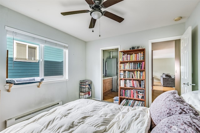 bedroom featuring a ceiling fan, connected bathroom, wood finished floors, and a baseboard radiator