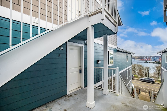 doorway to property with a water view