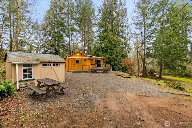 view of yard featuring an outbuilding and a shed