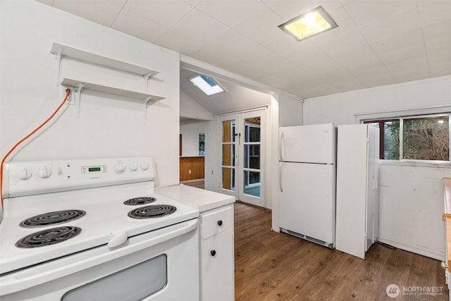 kitchen featuring light countertops, vaulted ceiling, wood finished floors, white appliances, and white cabinetry