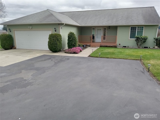 single story home featuring a shingled roof, a front lawn, concrete driveway, covered porch, and an attached garage