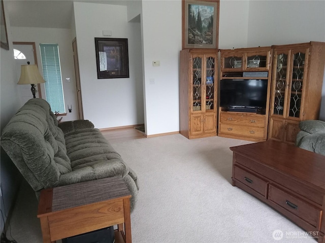 carpeted living area with baseboards