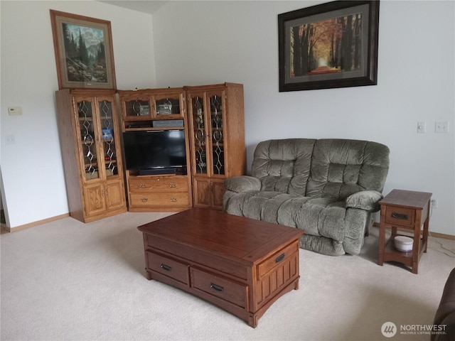 carpeted living room featuring baseboards