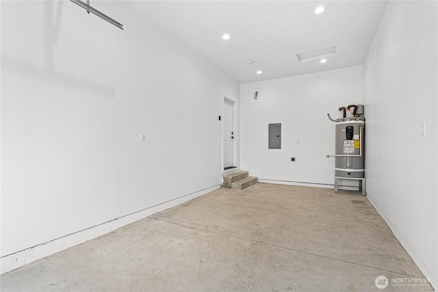 garage featuring electric panel, recessed lighting, and water heater