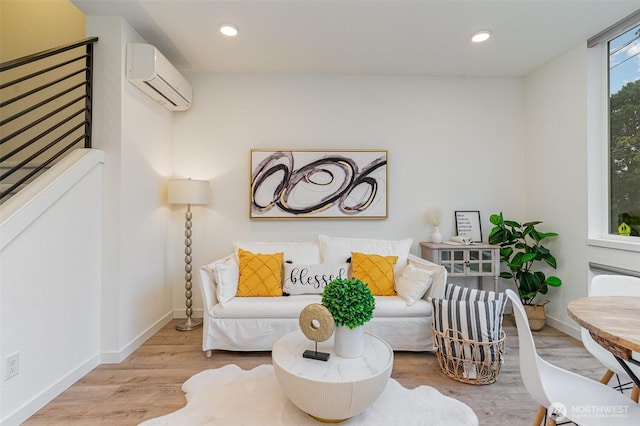 living area with recessed lighting, baseboards, wood finished floors, and a wall unit AC