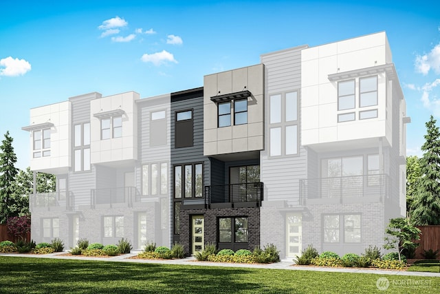 exterior space with stucco siding, brick siding, and a front yard