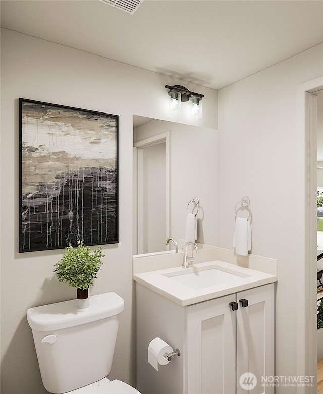 bathroom with toilet and vanity