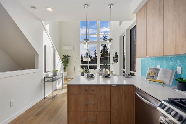 kitchen with light countertops, appliances with stainless steel finishes, modern cabinets, and backsplash