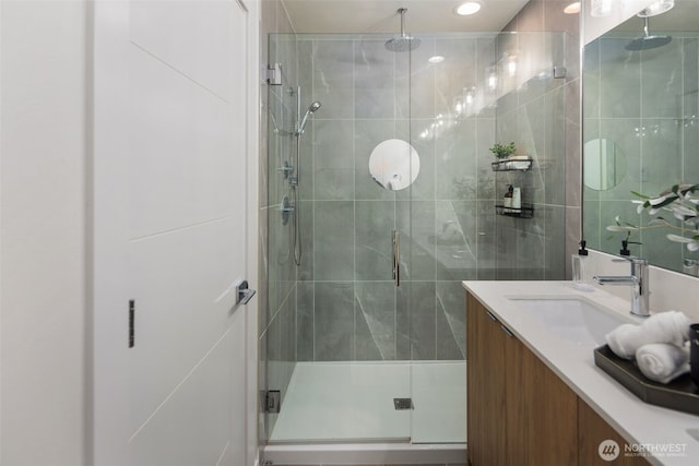 bathroom with a shower stall and vanity