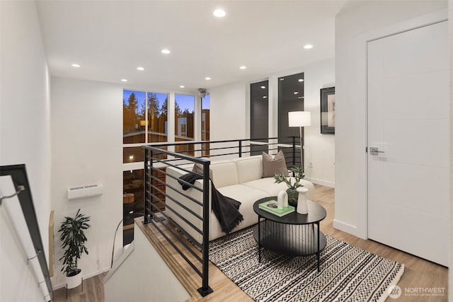 hall featuring recessed lighting, baseboards, and wood finished floors