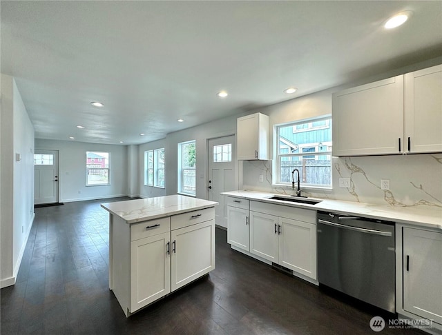 kitchen featuring dishwasher, dark wood-style floors, backsplash, and a sink