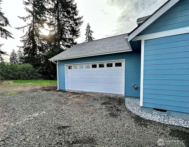 garage with gravel driveway