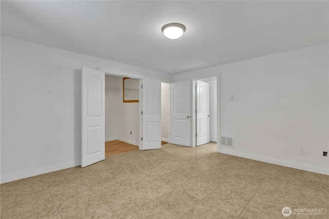 spare room with visible vents and baseboards