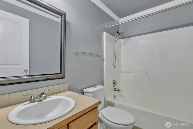 bathroom with vanity, toilet,  shower combination, and crown molding