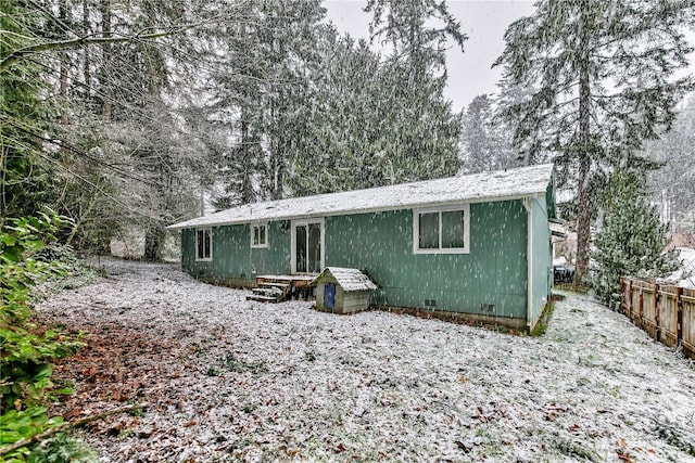 view of front of house featuring fence and crawl space