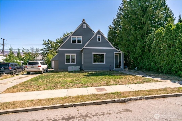 view of front of home with a front lawn and concrete driveway